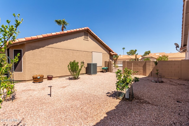 view of side of home featuring central AC