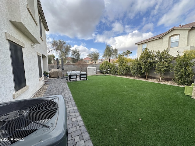 view of yard featuring cooling unit, an outdoor hangout area, and a patio area