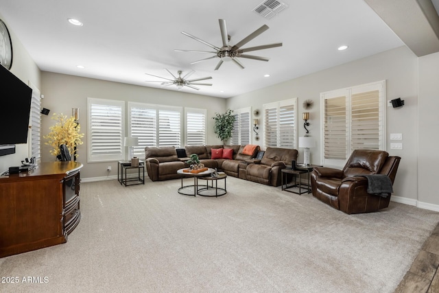 carpeted living room featuring ceiling fan