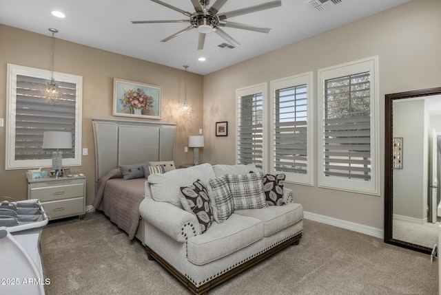 carpeted bedroom with ceiling fan with notable chandelier