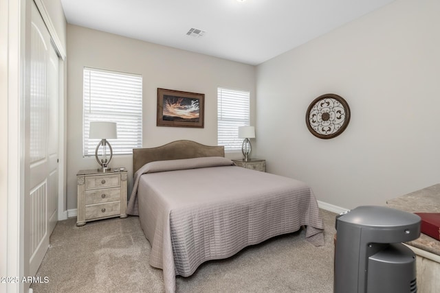 carpeted bedroom featuring a closet