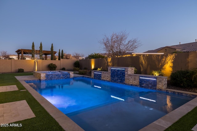 pool at dusk with pool water feature and an in ground hot tub