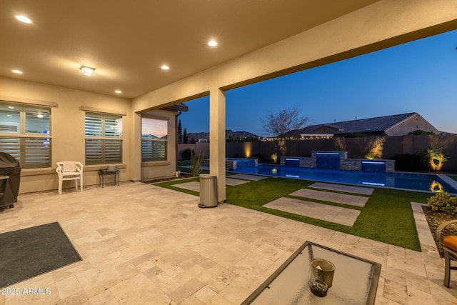 patio terrace at dusk with pool water feature and a pool with hot tub