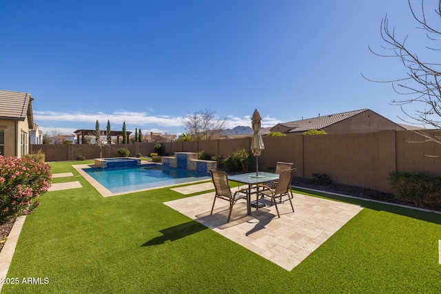 view of pool featuring an in ground hot tub, a patio area, and a lawn