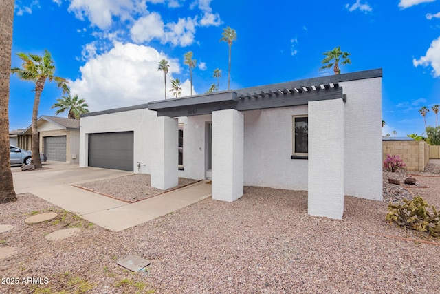 view of front of home featuring a garage, driveway, and stucco siding