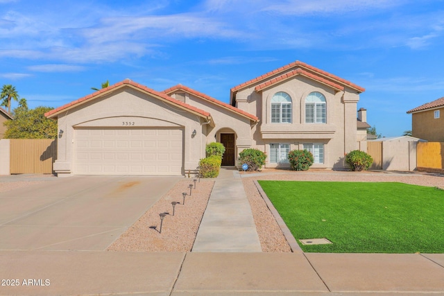 mediterranean / spanish-style home featuring a garage and a front lawn