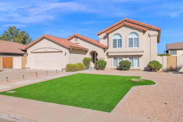 mediterranean / spanish-style home featuring a garage and a front lawn