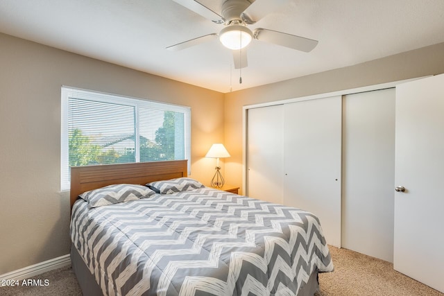 carpeted bedroom featuring a closet and ceiling fan