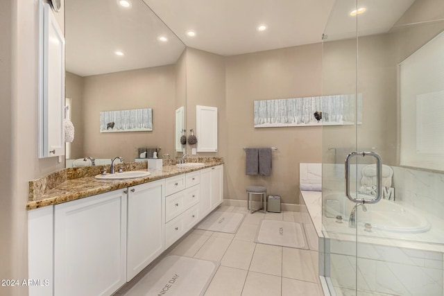 bathroom with tile patterned flooring, vanity, and a bathing tub