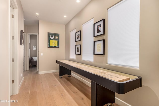 hallway with light hardwood / wood-style flooring