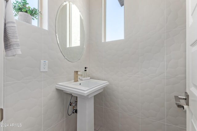 bathroom with tile walls