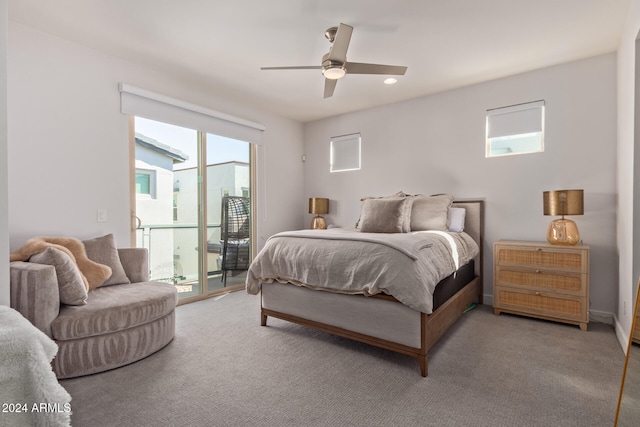 carpeted bedroom featuring access to outside, multiple windows, and ceiling fan