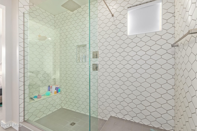 bathroom with a shower with door