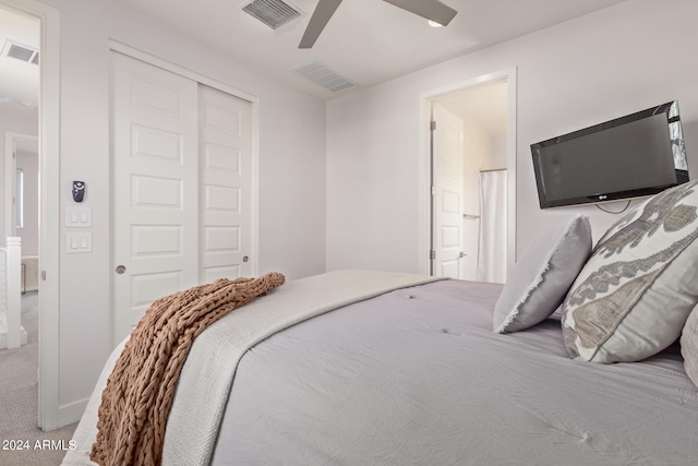 carpeted bedroom with ceiling fan and a closet