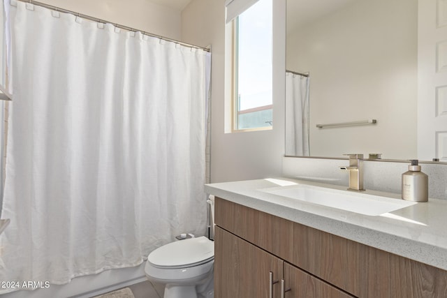 full bathroom featuring vanity, shower / bath combo with shower curtain, toilet, and tile patterned floors