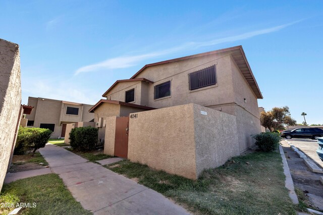 view of side of property featuring stucco siding