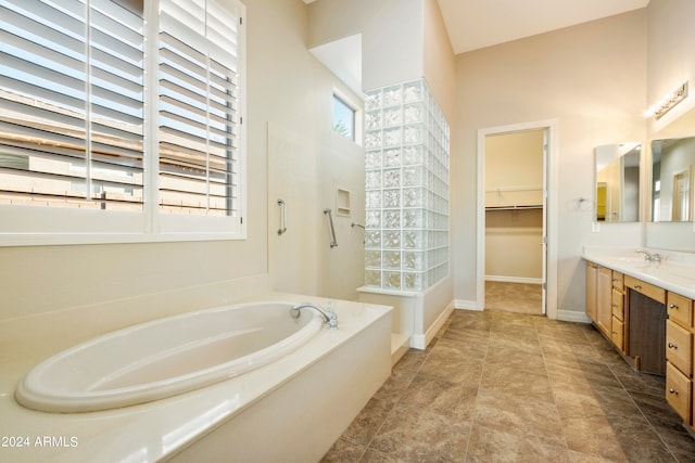 bathroom with vanity and a tub