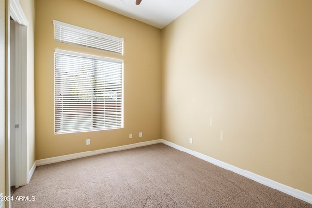 carpeted empty room with ceiling fan