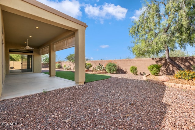 view of yard featuring a patio and ceiling fan