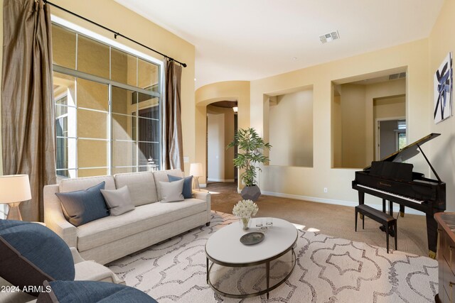 entrance foyer featuring light colored carpet and an inviting chandelier