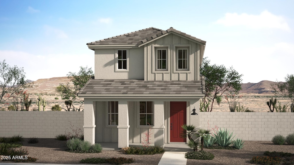 view of front of home with board and batten siding, a mountain view, a fenced front yard, and stucco siding