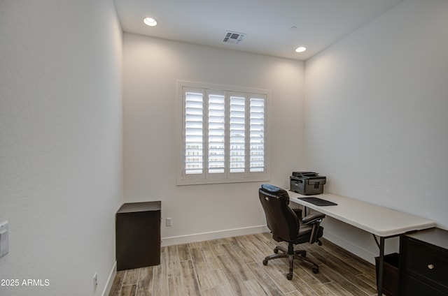 home office featuring baseboards, visible vents, wood finished floors, and recessed lighting