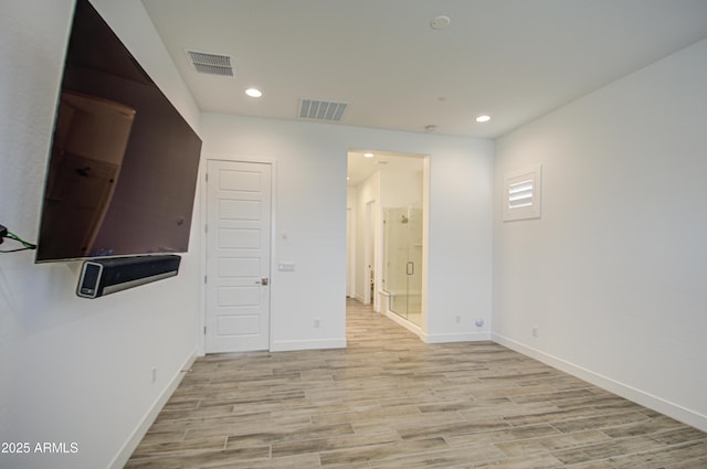 unfurnished room featuring light wood-type flooring, visible vents, and recessed lighting