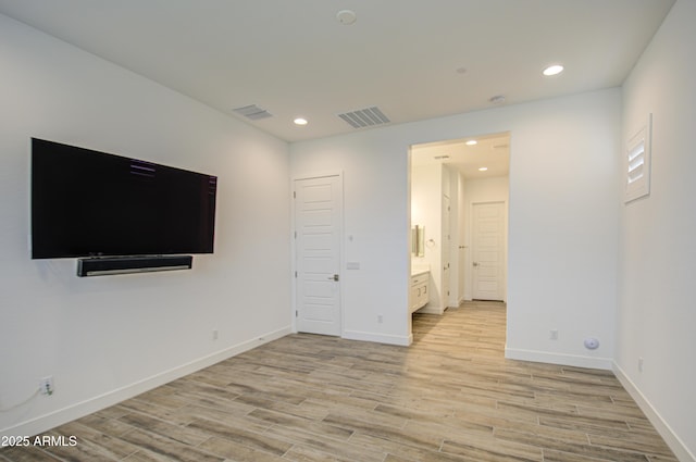 interior space with light wood-style floors, baseboards, visible vents, and recessed lighting