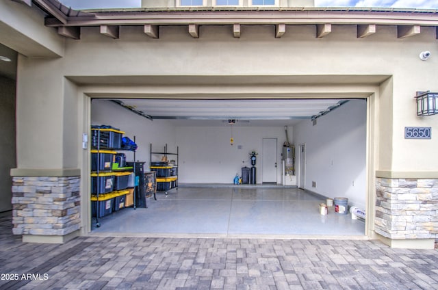 garage with decorative driveway