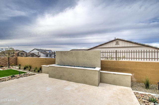 view of patio featuring fence