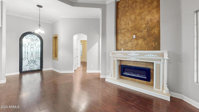 7171 W Quarter Horse Run, Coolidge, AZ 85128 - foyer with baseboards, wood finished floors, arched walkways, and a fireplace with raised hearth