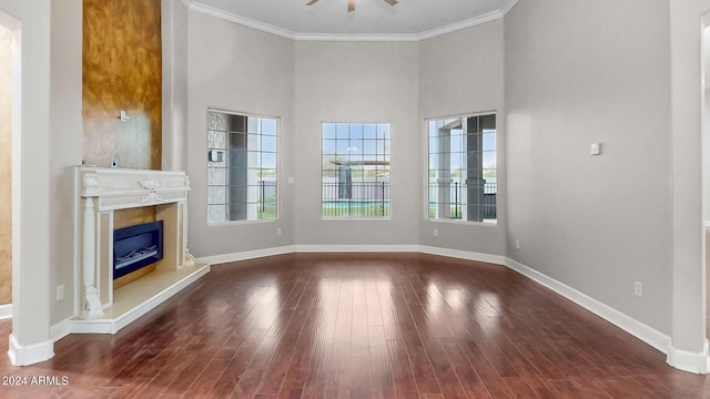 7171 W Quarter Horse Run, Coolidge, AZ 85128 - unfurnished living room with crown molding, wood finished floors, a glass covered fireplace, and a ceiling fan