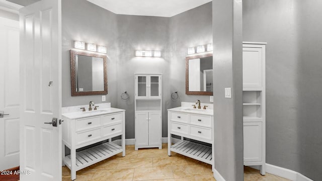 7171 W Quarter Horse Run, Coolidge, AZ 85128 - bathroom with baseboards, a sink, and two vanities