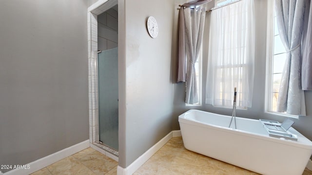 7171 W Quarter Horse Run, Coolidge, AZ 85128 - bathroom with a shower stall, baseboards, and a freestanding bath