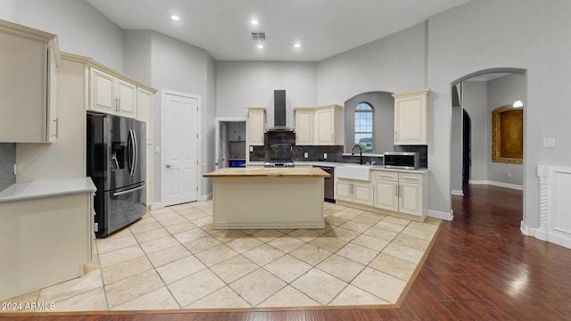 7171 W Quarter Horse Run, Coolidge, AZ 85128 - kitchen featuring butcher block countertops, cream cabinetry, wall chimney exhaust hood, and stainless steel appliances