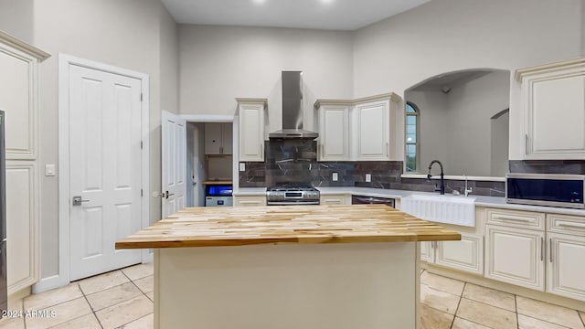 7171 W Quarter Horse Run, Coolidge, AZ 85128 - kitchen with wall chimney range hood, wood counters, appliances with stainless steel finishes, and arched walkways