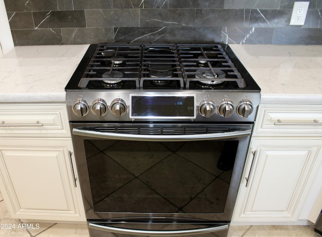 7171 W Quarter Horse Run, Coolidge, AZ 85128 - details featuring gas range, light stone counters, and backsplash
