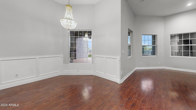 7171 W Quarter Horse Run, Coolidge, AZ 85128 - interior space with a wainscoted wall, wood-type flooring, a decorative wall, and a chandelier