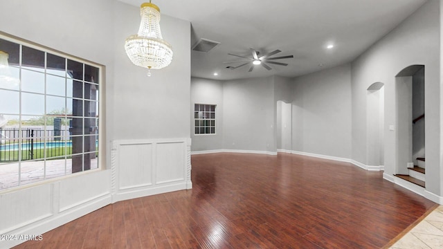 7171 W Quarter Horse Run, Coolidge, AZ 85128 - spare room featuring stairs, recessed lighting, ceiling fan with notable chandelier, arched walkways, and wood finished floors