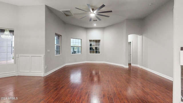 7171 W Quarter Horse Run, Coolidge, AZ 85128 - empty room with visible vents, baseboards, a ceiling fan, arched walkways, and hardwood / wood-style floors