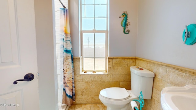 7171 W Quarter Horse Run, Coolidge, AZ 85128 - full bath with tile walls, toilet, a shower with shower curtain, and wainscoting