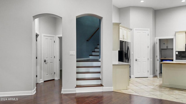7171 W Quarter Horse Run, Coolidge, AZ 85128 - stairs with baseboards, arched walkways, wood finished floors, and recessed lighting
