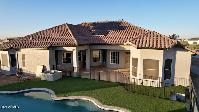 7171 W Quarter Horse Run, Coolidge, AZ 85128 - back of house featuring a tile roof, stucco siding, fence, a patio area, and roof mounted solar panels