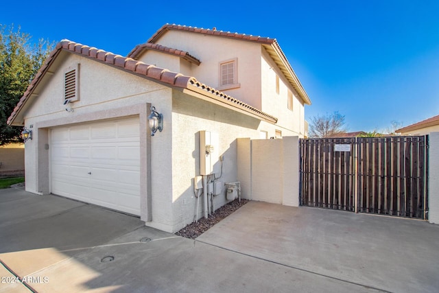 view of side of home featuring a garage