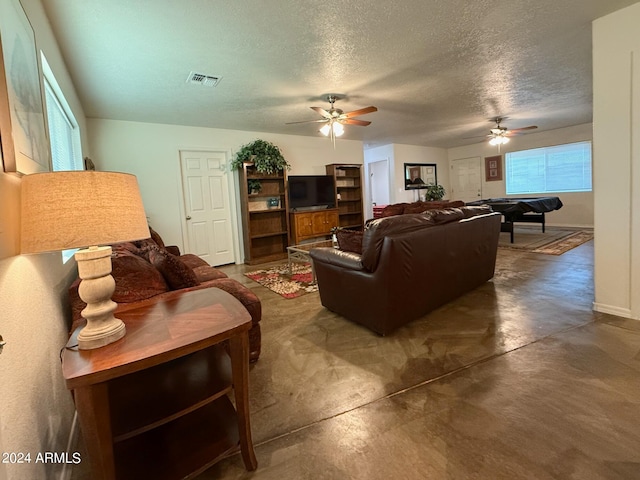 living room featuring ceiling fan, a textured ceiling, and billiards