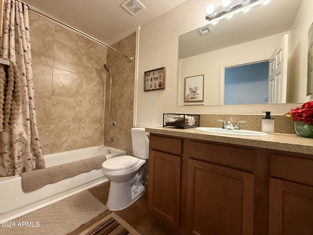 full bathroom with vanity, a textured ceiling, shower / tub combo with curtain, and toilet