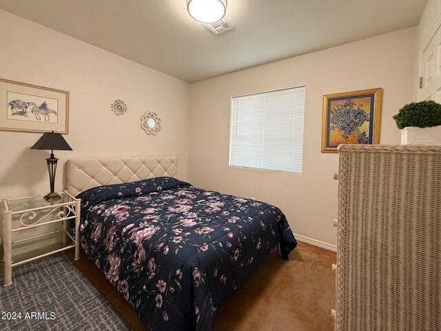 bedroom with dark colored carpet