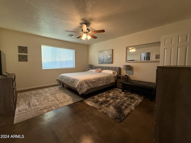 bedroom featuring a textured ceiling, concrete floors, and ceiling fan