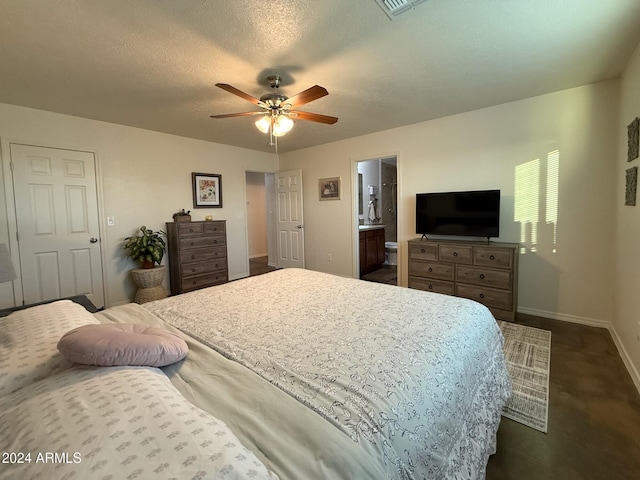 bedroom with connected bathroom, dark colored carpet, a textured ceiling, and ceiling fan