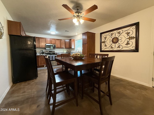 carpeted dining area with ceiling fan and a textured ceiling